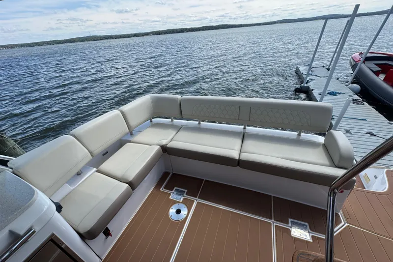 Slide: The Image of Luxurious seating area on a 2019 Regal 42 Fly yacht, overlooking serene waters. - 22