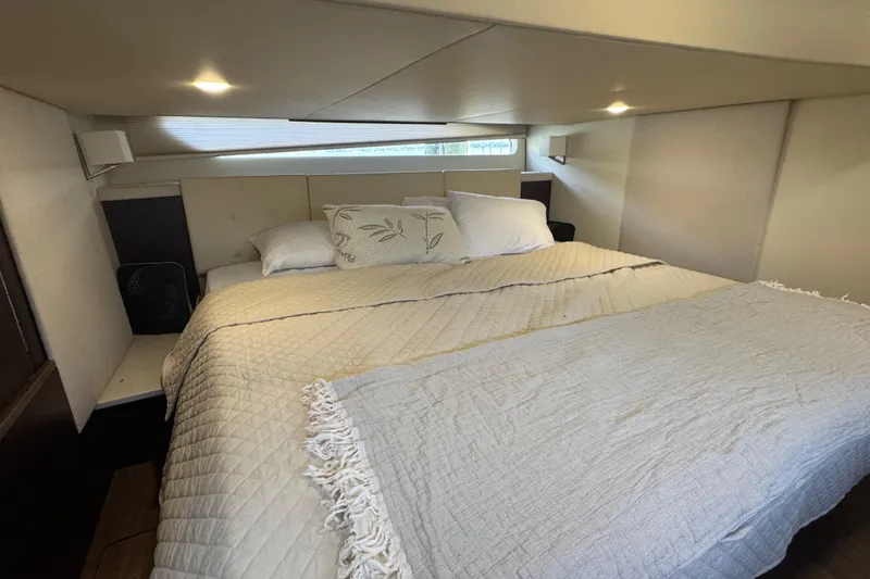 Slide: The Image of Luxurious bedroom interior of 2019 Regal 42 Fly yacht with cozy bedding. - 29