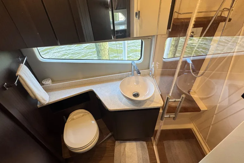 Slide: The Image of Luxurious bathroom in 2019 Regal 42 Fly yacht with modern fixtures and large window. - 30