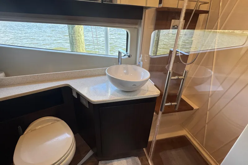 Slide: The Image of Luxurious bathroom in 2019 Regal 42 Fly yacht with modern fixtures and water view. - 32