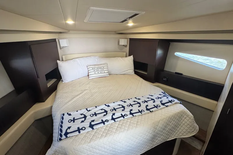 Slide: The Image of Luxurious cabin interior of 2019 Regal 42 Fly yacht with cozy bedding and nautical decor. - 35