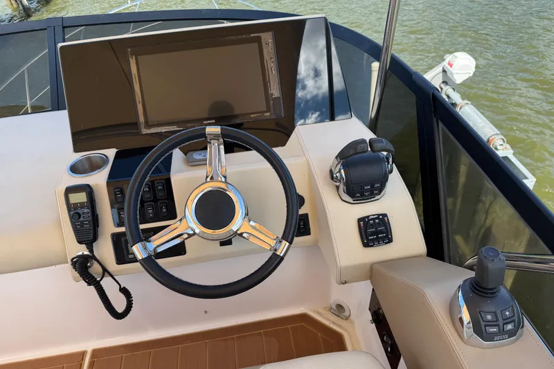 Slide: The Image of Steering console of 2019 Regal 42 Fly yacht with modern controls and navigation display. - 44