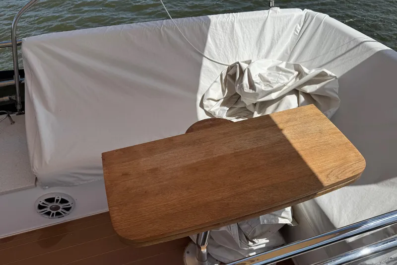 Slide: The Image of Wooden table on a 2019 Regal 42 Fly yacht with white seating and water view. - 46