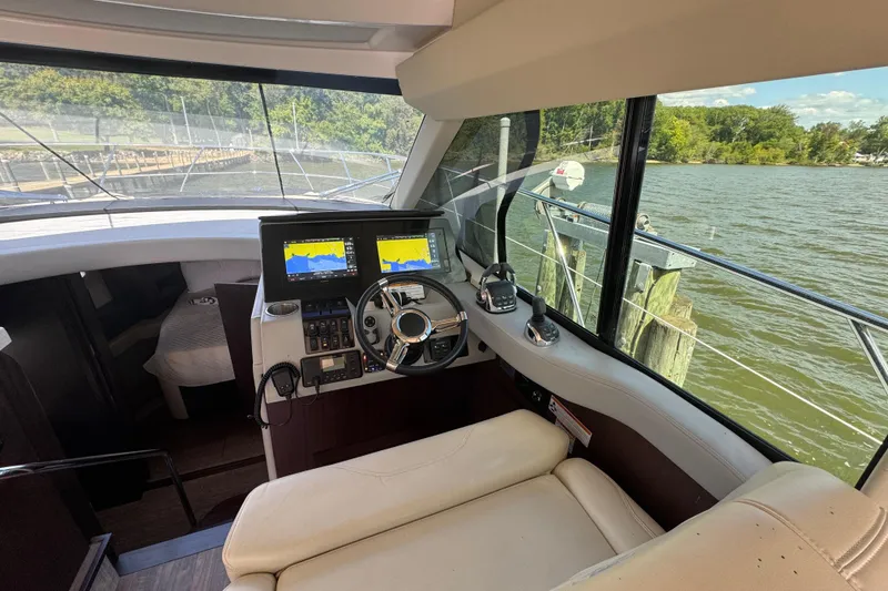 Slide: The Image of Interior view of 2019 Regal 42 Fly yacht cockpit with navigation screens and steering wheel. - 52