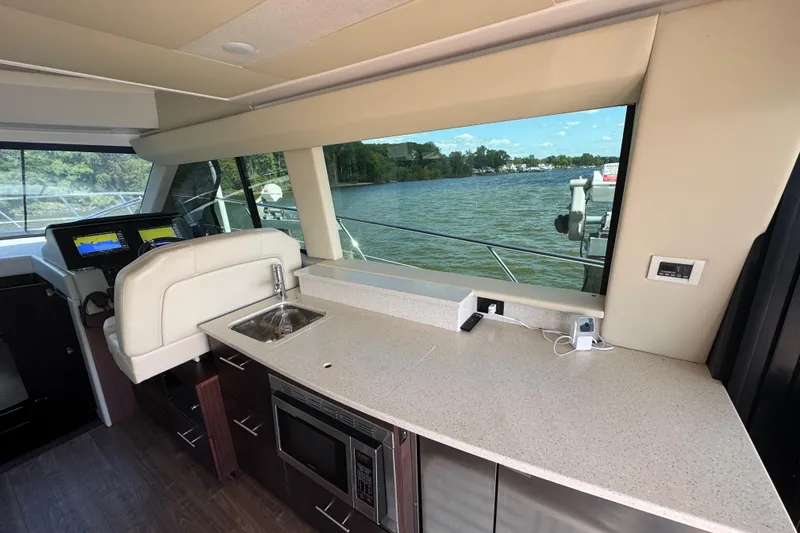 Slide: The Image of Luxurious interior of 2019 Regal 42 Fly yacht with kitchenette and scenic water view. - 56