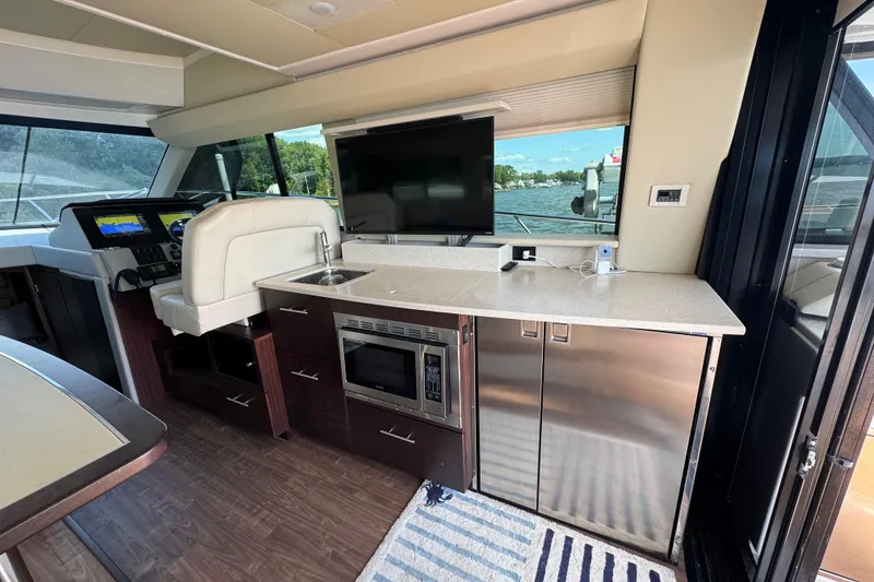 Slide: The Image of Luxurious interior of 2019 Regal 42 Fly yacht with modern kitchen and navigation area. - 60