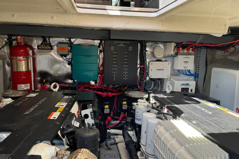 Slide: The Image of Engine room of a 2019 Regal 42 Fly yacht, showcasing equipment and wiring. - 61