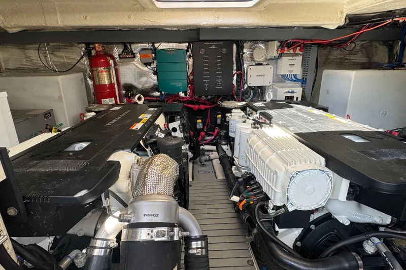 Slide: The Image of Engine room of a 2019 Regal 42 Fly yacht, showcasing dual engines and equipment. - 64