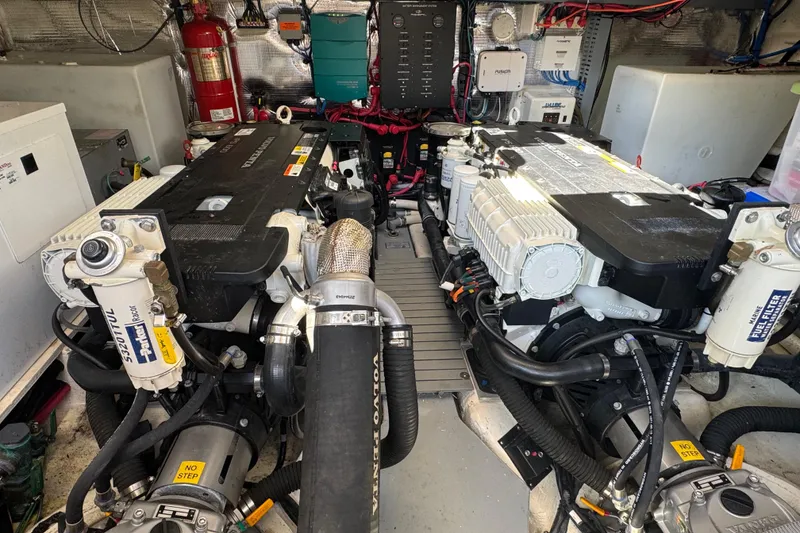 Slide: The Image of Engine room of a 2019 Regal 42 Fly yacht, featuring dual engines and mechanical components. - 68
