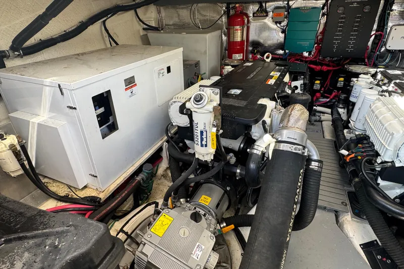 Slide: The Image of Engine room of a 2019 Regal 42 Fly yacht, showcasing mechanical components and systems. - 69
