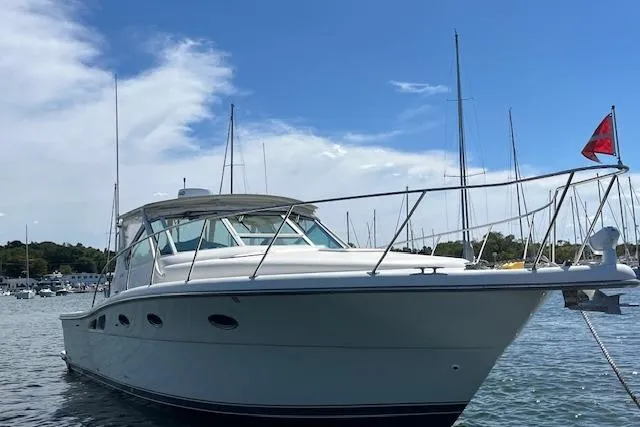 Slide: The Image of 1998 Tiara Yachts 3500 Open boat on water, clear sky background. - 13