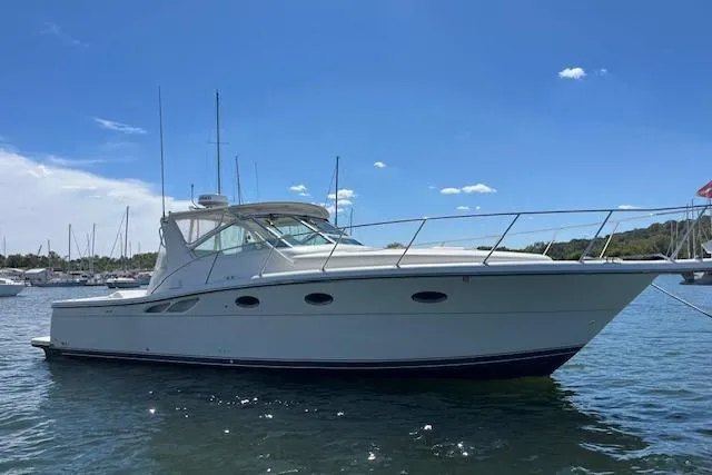 Slide: The Image of 1998 Tiara Yachts 3500 Open boat on water under clear blue sky. - 14