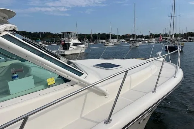 Slide: The Image of 1998 Tiara Yachts 3500 Open docked in a marina with other boats. - 15