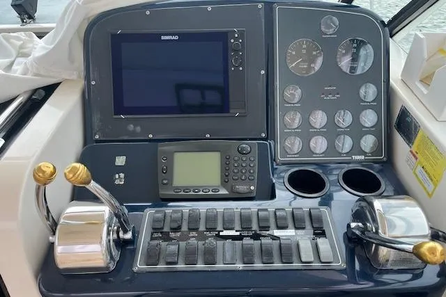 Slide: The Image of Control panel of a 1998 Tiara Yachts 3500 Open, featuring navigation and throttle controls. - 23