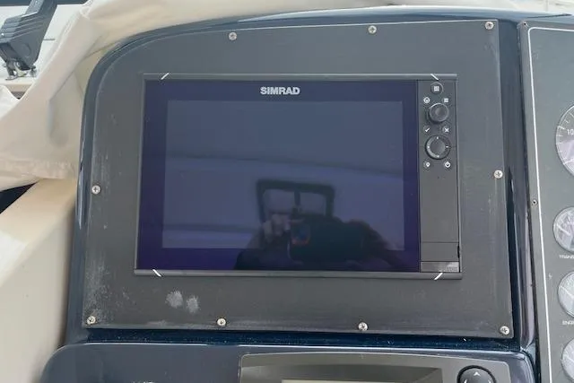 Slide: The Image of Simrad display on 1998 Tiara Yachts 3500 Open dashboard, showcasing navigation technology. - 24