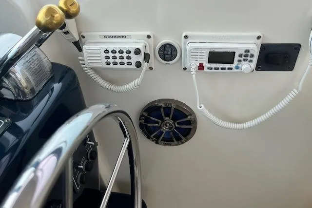 Slide: The Image of 1998 Tiara Yachts 3500 Open helm with radio controls and steering wheel. - 27