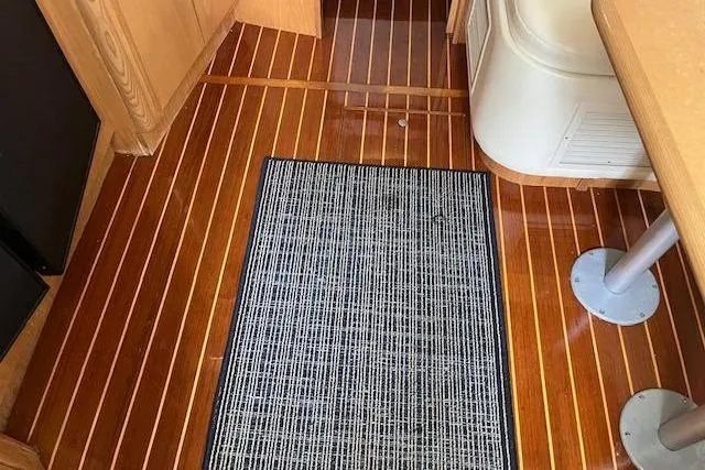 Slide: The Image of 1998 Tiara Yachts 3500 Open interior with polished wood flooring and a textured rug. - 30