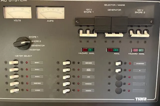 Slide: The Image of Electrical control panel of a 1998 Tiara Yachts 3500 Open boat, featuring meters and switches. - 32