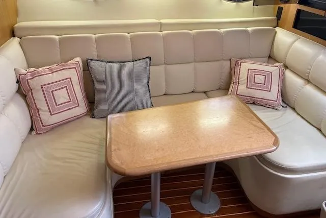 Slide: The Image of 1998 Tiara Yachts 3500 Open interior with beige seating and wooden table. - 37