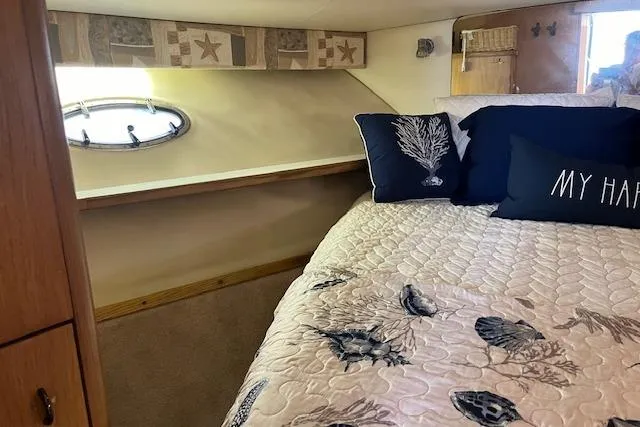 Slide: The Image of 1998 Tiara Yachts 3500 Open cabin with cozy bed and nautical-themed decor. - 39