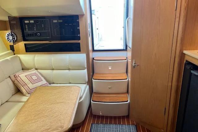 Slide: The Image of Interior of 1998 Tiara Yachts 3500 Open, featuring seating, stairs, and control panels. - 41