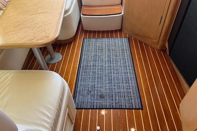 Slide: The Image of Interior of 1998 Tiara Yachts 3500 Open with wood flooring and seating area. - 42