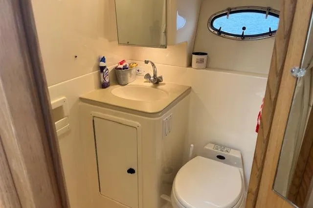 Slide: The Image of Bathroom interior of 1998 Tiara Yachts 3500 Open, featuring sink and toilet. - 44