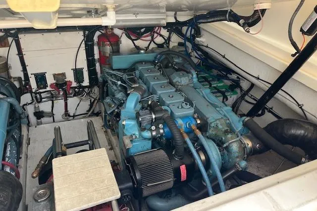 Slide: The Image of 1998 Tiara Yachts 3500 Open engine compartment with visible machinery and wiring. - 48