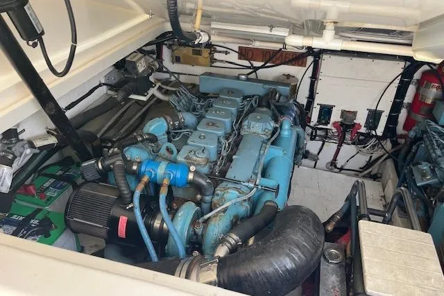 Slide: The Image of Engine room of 1998 Tiara Yachts 3500 Open, showcasing blue engine and components. - 49