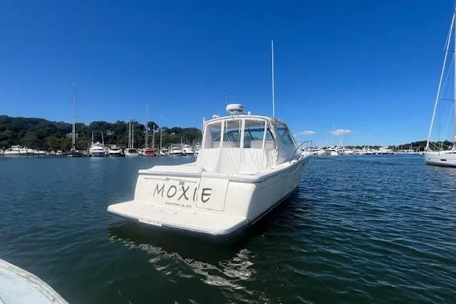 Slide: The Image of 1998 Tiara Yachts 3500 Open boat named "Moxie" docked in a marina. - 5