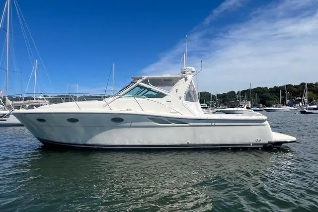 Slide: The Image of 1998 Tiara Yachts 3500 Open boat on calm water under a clear blue sky. - 8