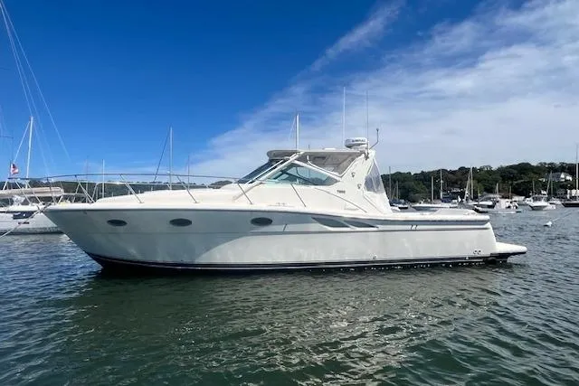 Slide: The Image of 1998 Tiara Yachts 3500 Open boat on calm water under a clear blue sky. - 9