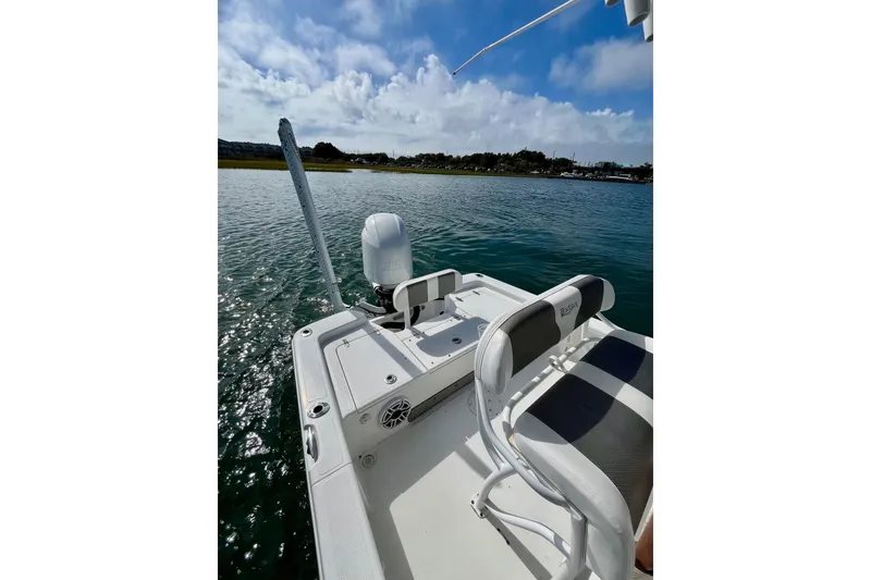 Slide: The Image of 2022 BlackJack 224 boat on calm water, featuring sleek seating and modern design. - 11