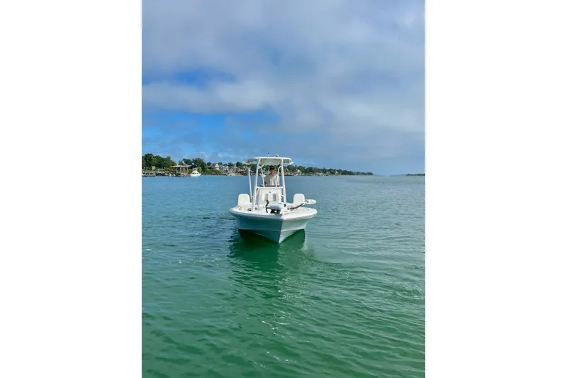 Slide: The Image of 2022 BlackJack 224 boat on calm water under a clear blue sky. - 15