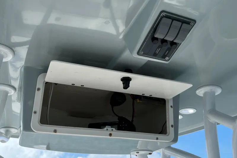 Slide: The Image of Open storage compartment and control panel on 2022 BlackJack 224 boat. - 7