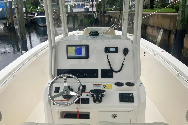 Slide: The Image of 2024 Cobia 280 Center Console boat dashboard with navigation and control systems. - 12