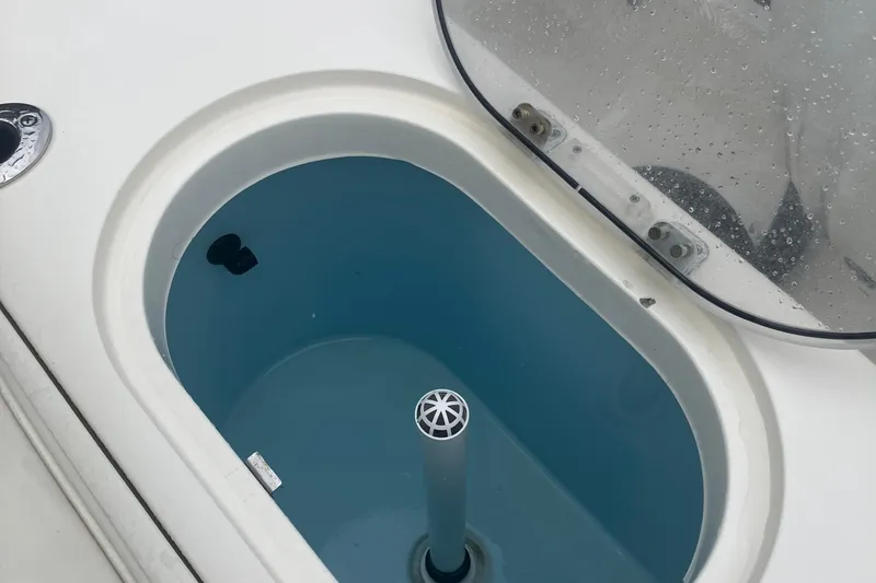 Slide: The Image of Livewell of 2024 Cobia 280 Center Console boat, open lid, blue interior. - 13