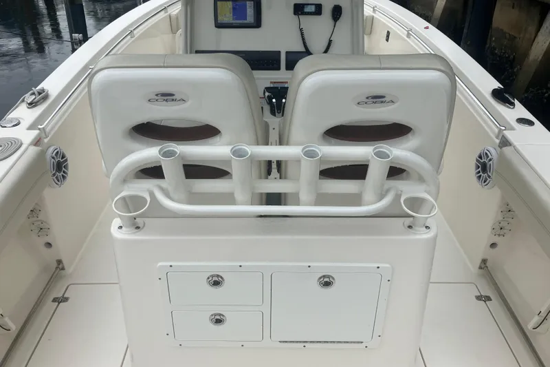 Slide: The Image of 2024 Cobia 280 Center Console boat interior with dual seats and rod holders. - 9