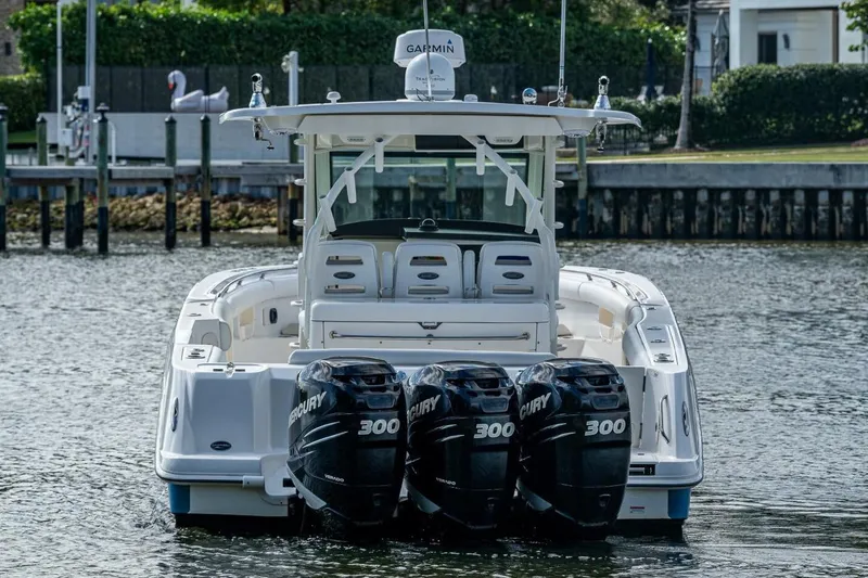 Slide: The Image of 2011 Boston Whaler 370 Outrage with triple Mercury 300 engines on the water. - 14