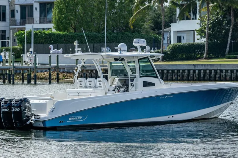 Slide: The Image of 2011 Boston Whaler 370 Outrage boat with triple Mercury engines on a calm waterway. - 19