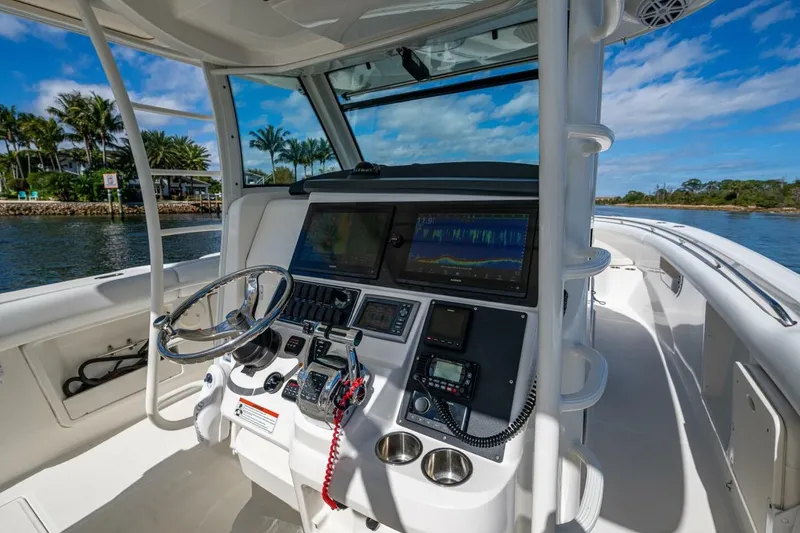 Slide: The Image of Boston Whaler 370 Outrage 2011 helm with advanced navigation system and scenic water view. - 4