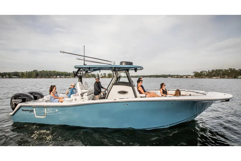 The Image of 2026 Tidewater 302 CC Adventure boat on trailer, parked near a warehouse. - 0