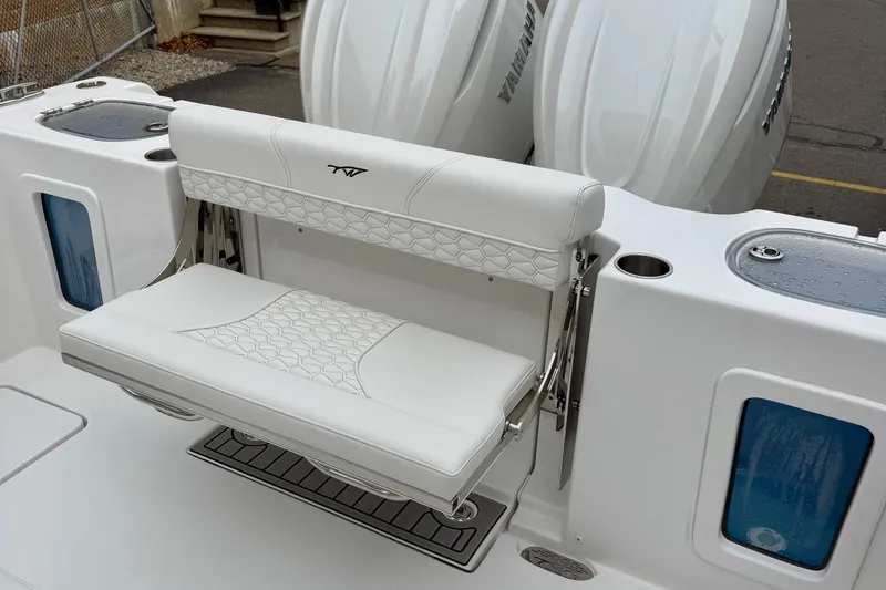Slide: The Image of 2026 Tidewater 302 CC Adventure boat interior with white seating and dual Yamaha engines. - 14