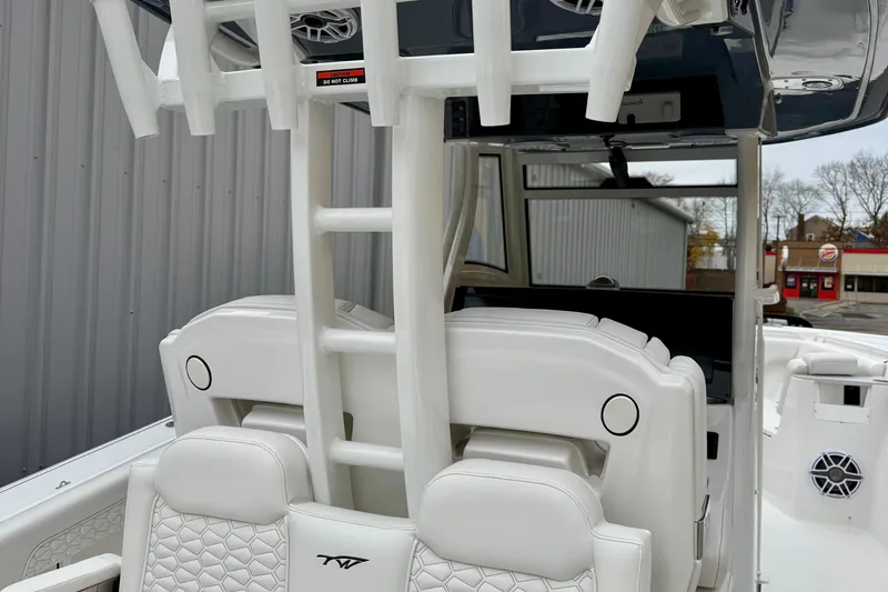 Slide: The Image of 2026 Tidewater 302 CC Adventure boat with white foldable bench seat and dual engines. - 15