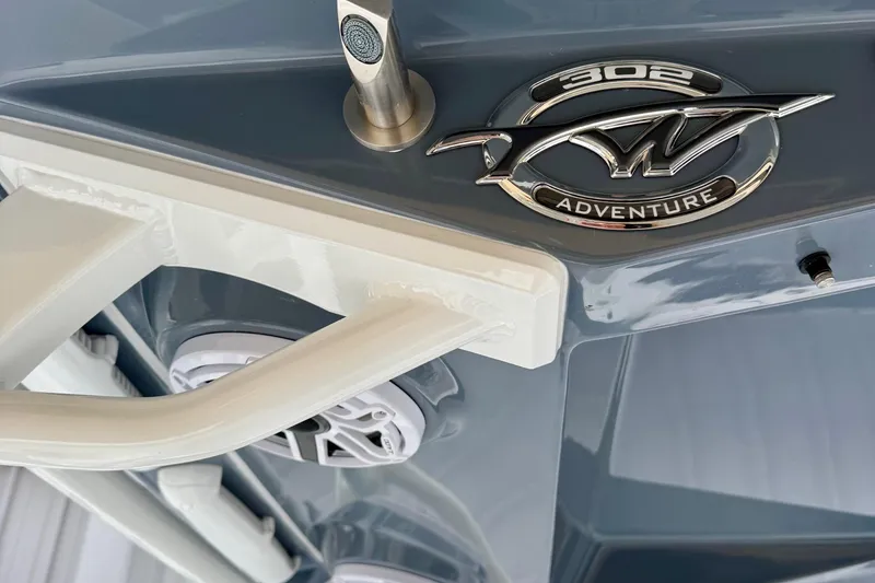 Slide: The Image of 2026 Tidewater 302 CC Adventure boat speakers and rod holders, close-up view. - 24