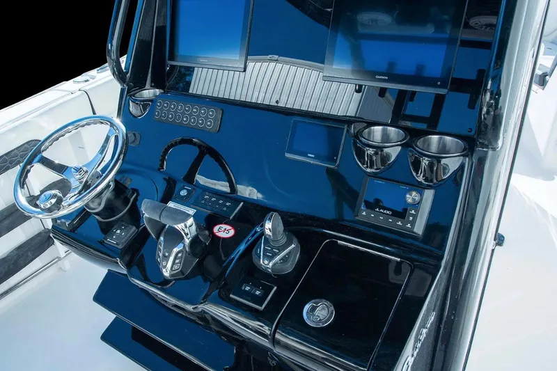 Slide: The Image of 2026 Tidewater 302 CC Adventure boat in a marina storage area, surrounded by other boats. - 3