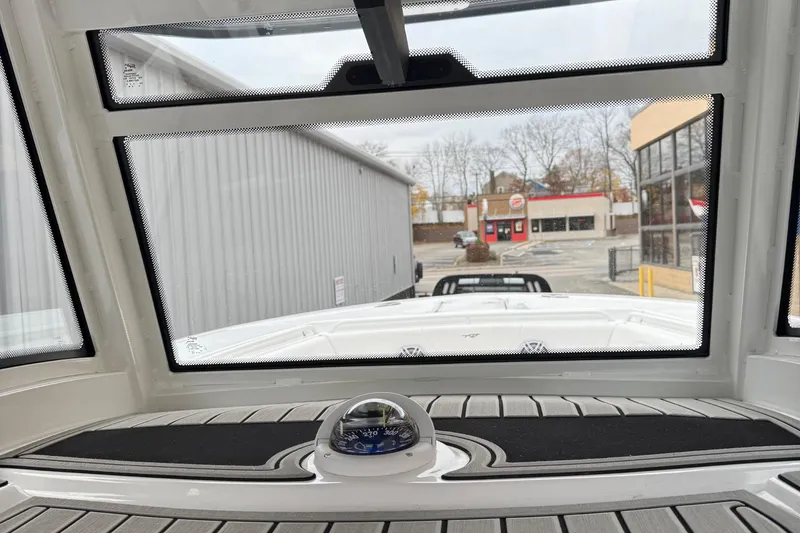 Slide: The Image of Steering console of 2026 Tidewater 302 CC Adventure boat with control panel and steering wheel. - 30