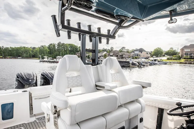 Slide: The Image of 2026 Tidewater 302 CC Adventure boat on trailer with Yamaha engine, parked outdoors. - 4