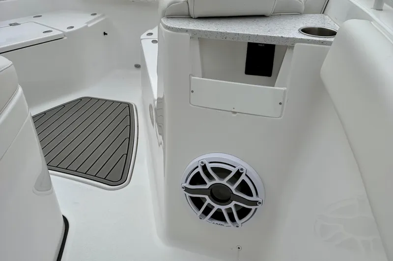 Slide: The Image of 2026 Tidewater 302 CC Adventure boat interior with white cushioned seating and storage compartments. - 42