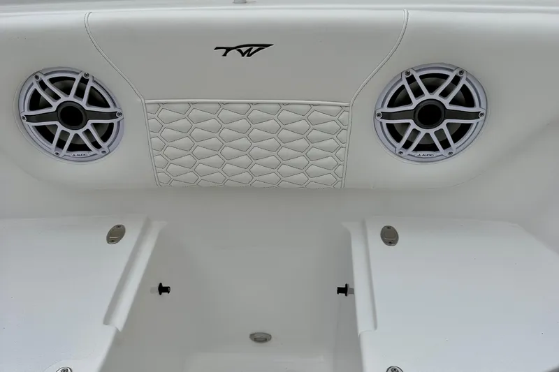 Slide: The Image of 2026 Tidewater 302 CC Adventure boat interior with storage compartment and cup holders. - 46